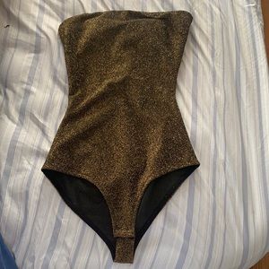 Gold glittery body suit with adjustable bow